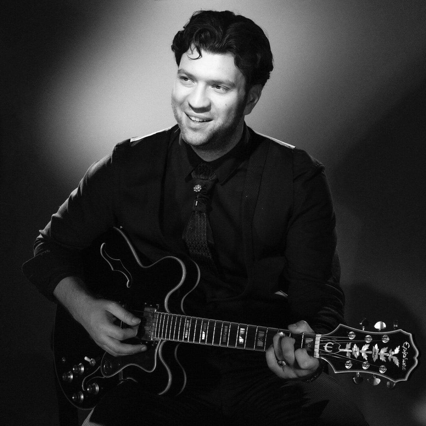 Marcel Gorlami, relaxed portrait with guitar